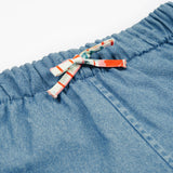 Close up of the frugi marigold reversible shorts, paint a floral / denim - GOTS organic cotton kids reversible shorts showing the denim and waist drawstring detail