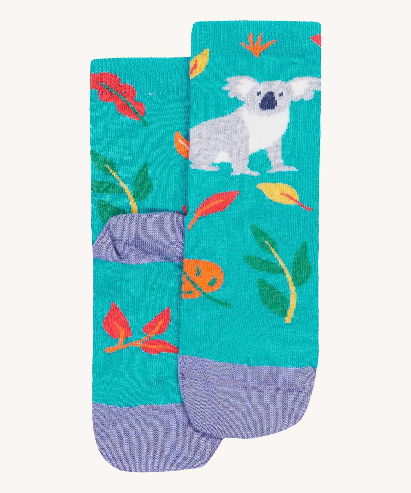 A close up of the Frugi koala rock my socks. A bright blue sock with a grey koala print on the front with coloured leaves. Features a light purple heel and toe contrast panel on organic cotton fabric