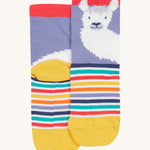 A close up of the Frugi llama rock my socks. A lilac and striped sock with a white llama print on the front and back Features a yellow heel and toe contrast panel with red ankle cuff trim on organic cotton fabric