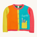 Frugi kids Rose pocket cardigan, happy pen pot - GOTS organic knitted cotton kids buttoned cardigan in pink, light blue orange and orange block colours. Features a yellow front pocket with an applique of pens and pencils with a happy slogan embroidery.