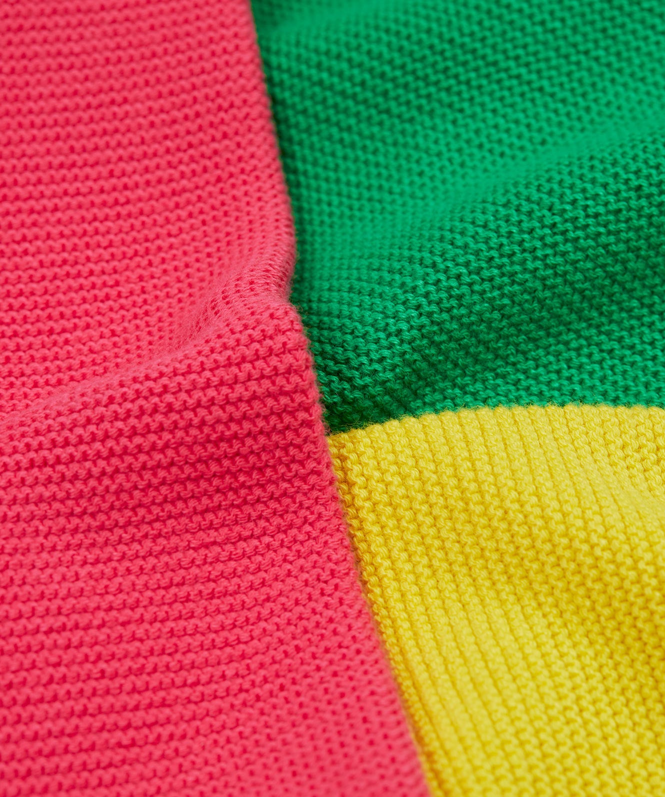 Close up of the Frugi kids Rose pocket cardigan, happy pen pot. Showing the pink yellow and green panel detail on organic knitted cotton fabric