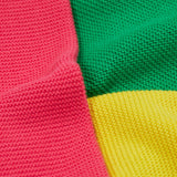 Close up of the Frugi kids Rose pocket cardigan, happy pen pot. Showing the pink yellow and green panel detail on organic knitted cotton fabric