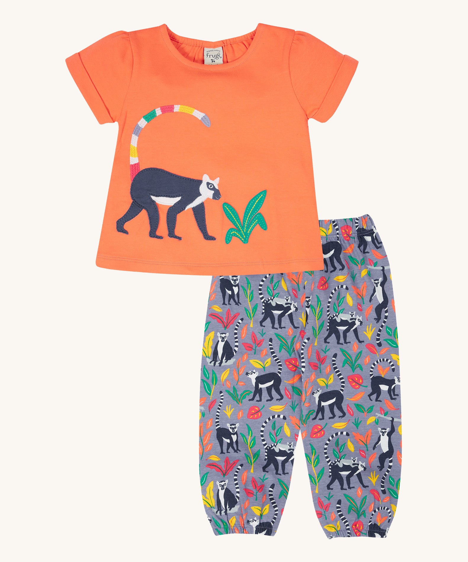 Frugi Rowenna outfit, lemur laugh - GOTS organic cotton kids two piece outfit with a coral short sleeve top and light purple bottoms. Feature an appliqué of a lemur on the top and printed lemurs with coloured leaves on the bottoms