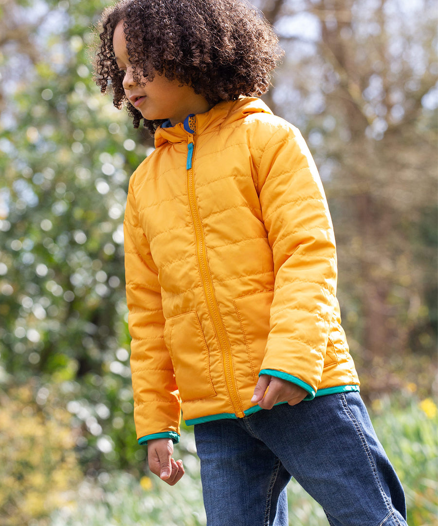 A child wearing the Frugi Children's Reversible Toasty Trail Jacket - Safari Camo