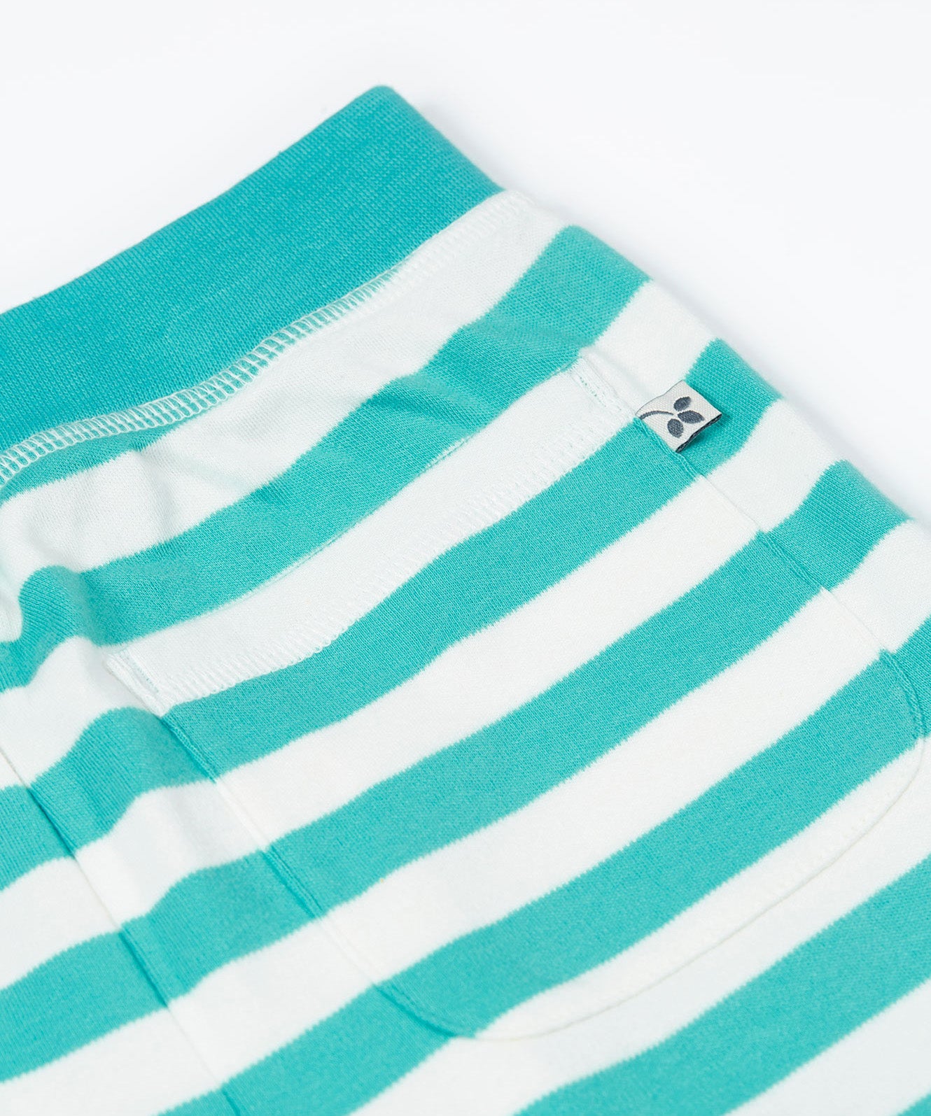 Close up of the Frugi kids sunny sea moss short - showing the back pocket and blue waist band on blue and white stripe organic cotton fabric