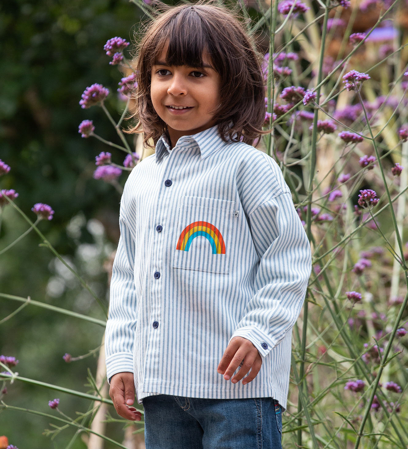 Frugi kids shacket, shirt with blue and white stripes and rainbow design worn by a child