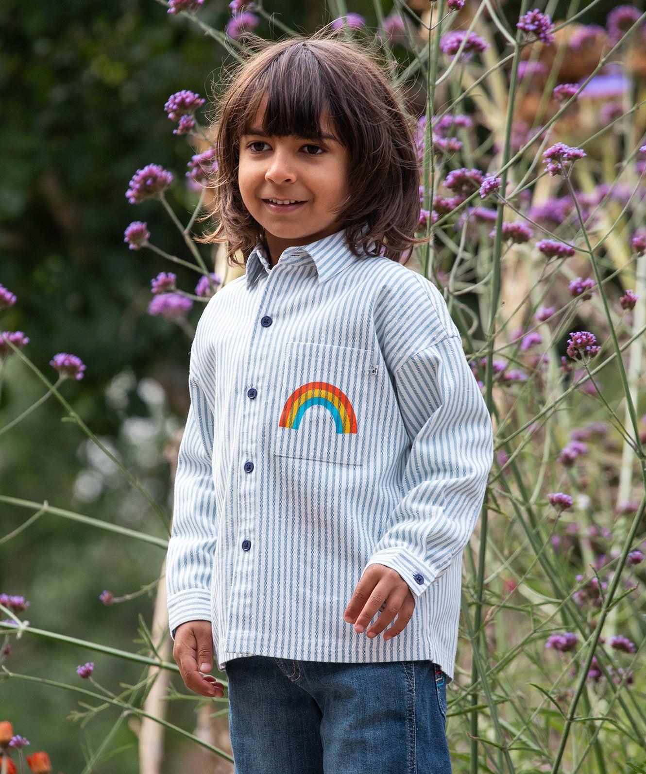 Frugi kids shacket, shirt with blue and white stripes and rainbow design worn by a child