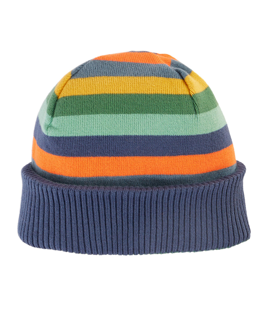 A child wearing the Frugi Children's Voyager Reversible Hat - Navy Blue/Mountains