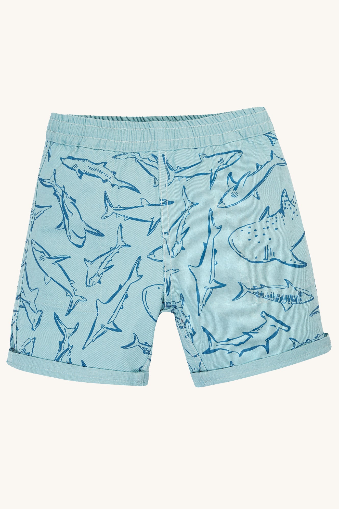 A closer look of the Jawsome shark print on the Frugi Children Organic Cotton Rocky Reversible Shorts - Stingray / Jawsome. A plain pale blue short with yellow drawstring on one side and a Jawsoms shark outline print on the reverse