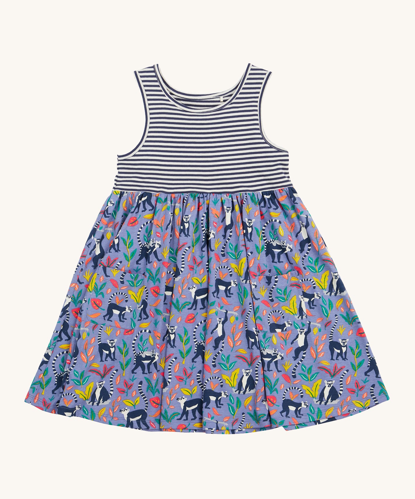 Frugi kids summer holiday dress lemur laughs- GOTS organic cotton kids sleeveless summer dress with a navy and white stripe top half and lemurs on the bottom half surrounded by different coloured leaves  on purple organic cotton fabric