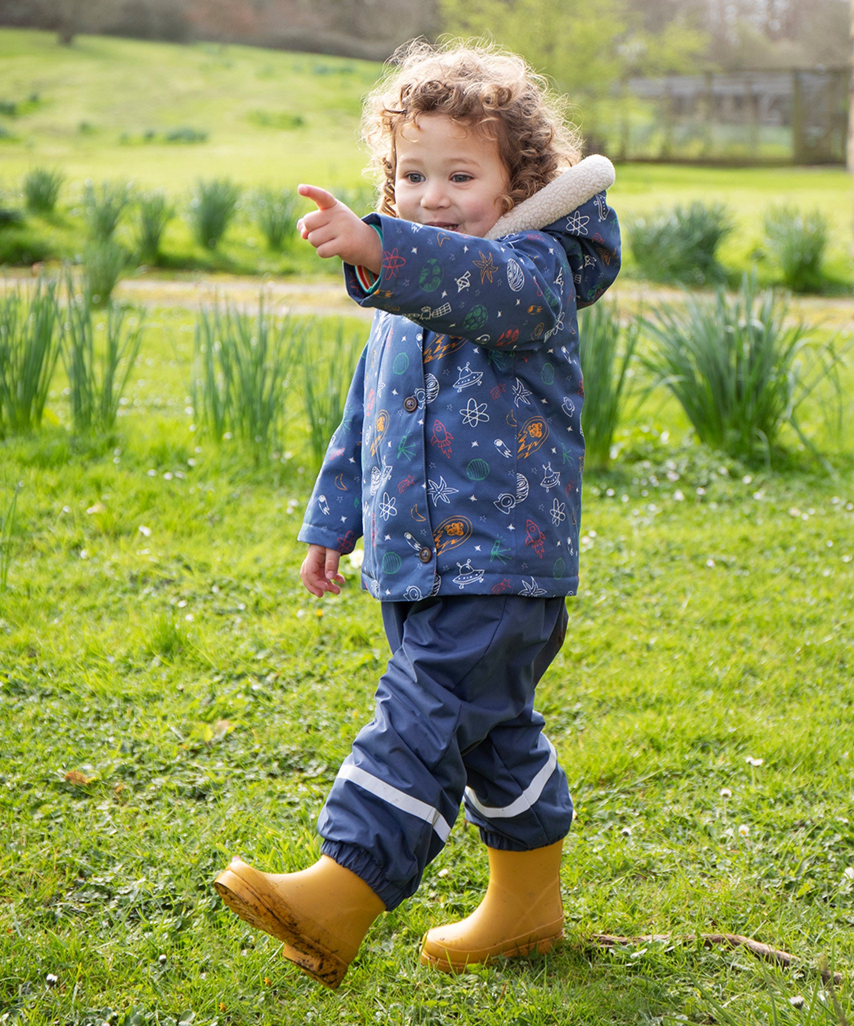 A closer look at the pop fasteners on the Frugi Children's Little Waterproof Dungarees - Navy Blue