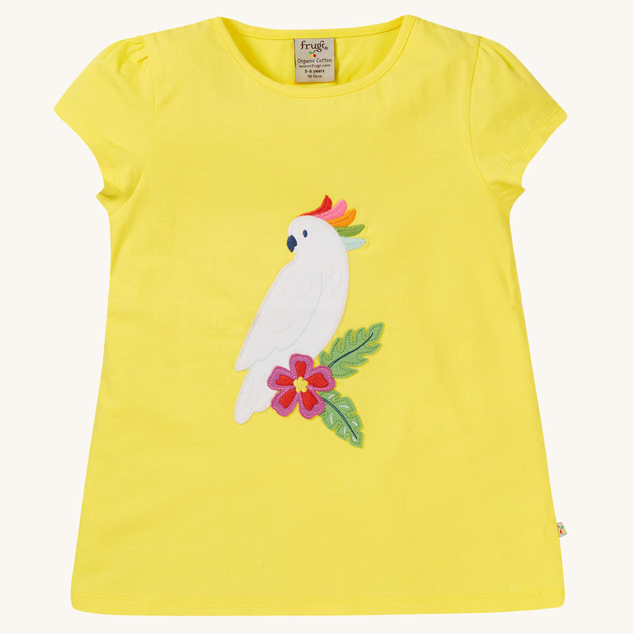 Frugi Children's Organic Cotton Cassia Applique T-Shirt - Cockatoo. A gorgeous sunny yellow, organic cotton Frugi T-Shirt for children features a gorgeous cockatoo applique with a colourful rainbow crest