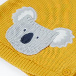 A close up of the organic knitted cotton grey koala bear pocket of the Frugi kids yellow koala cardigan 