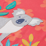 Close up of the Frugi kids flora fun koala t-shirt. Showing the appliqué detail of the grey koala next to 3 bamboo shoots on light pink organic cotton fabric with pastel orange floral prints