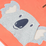 Close up of the Frugi kids koala half zip hoodie showing the appliqué of a grey koala head on coral organic cotton fabric