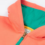 Close up of the Frugi kids koala half zip. Showing the hood and zip detail on coral organic cotton fabric