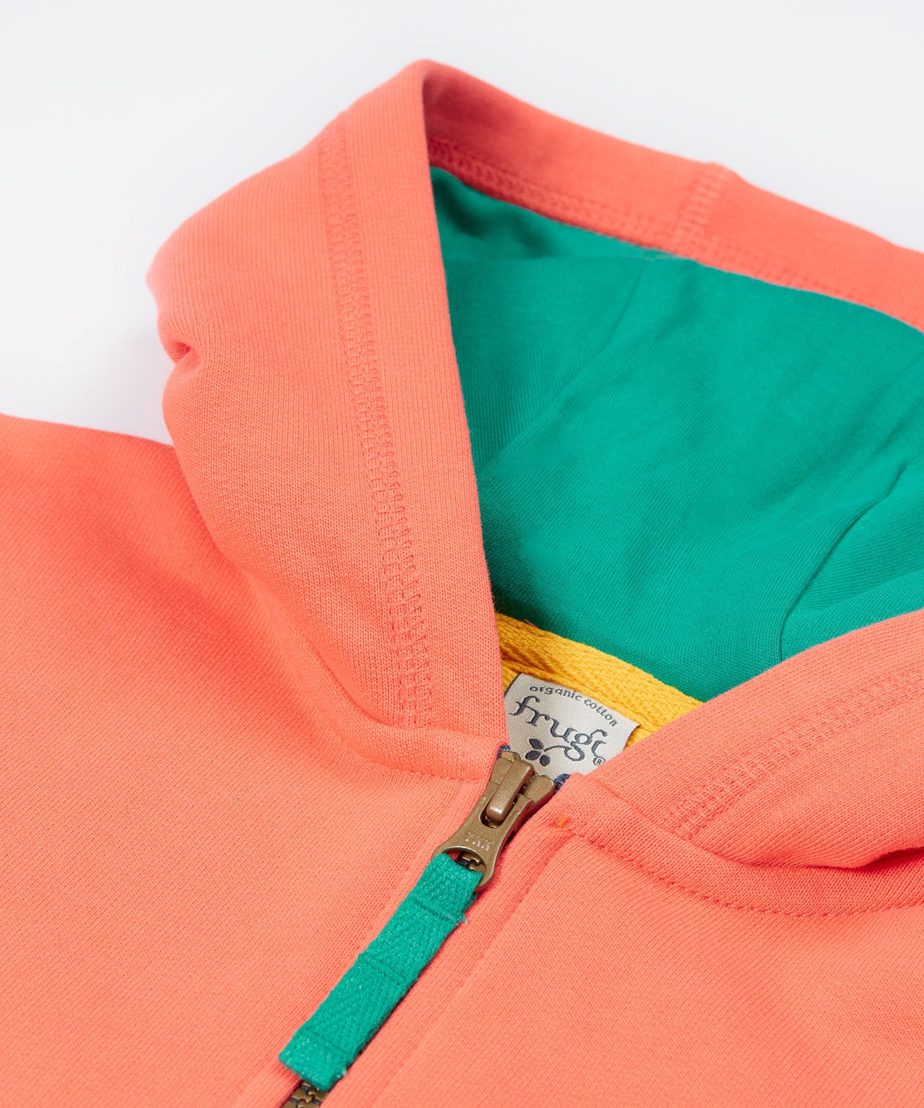 Close up of the Frugi kids koala half zip. Showing the hood and zip detail on coral organic cotton fabric