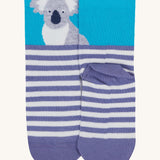 A close up of the Frugi koala sock. Showing the koala design on the light blue cuff on purple and white stripe organic cotton fabric