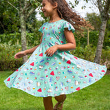 A child wearing a Frugi Let's Bake Morwenna Skater Dress