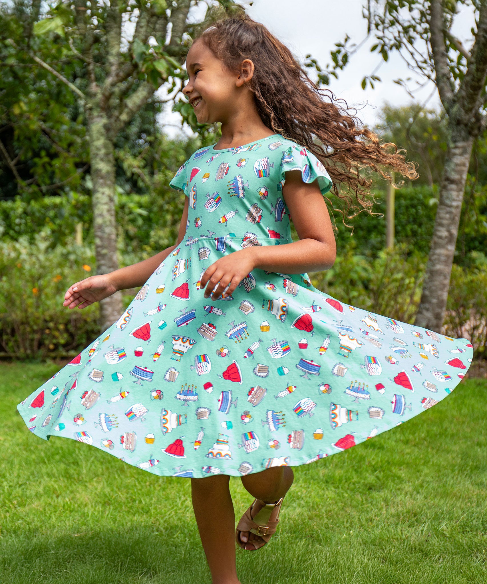 A child wearing a Frugi Let's Bake Morwenna Skater Dress