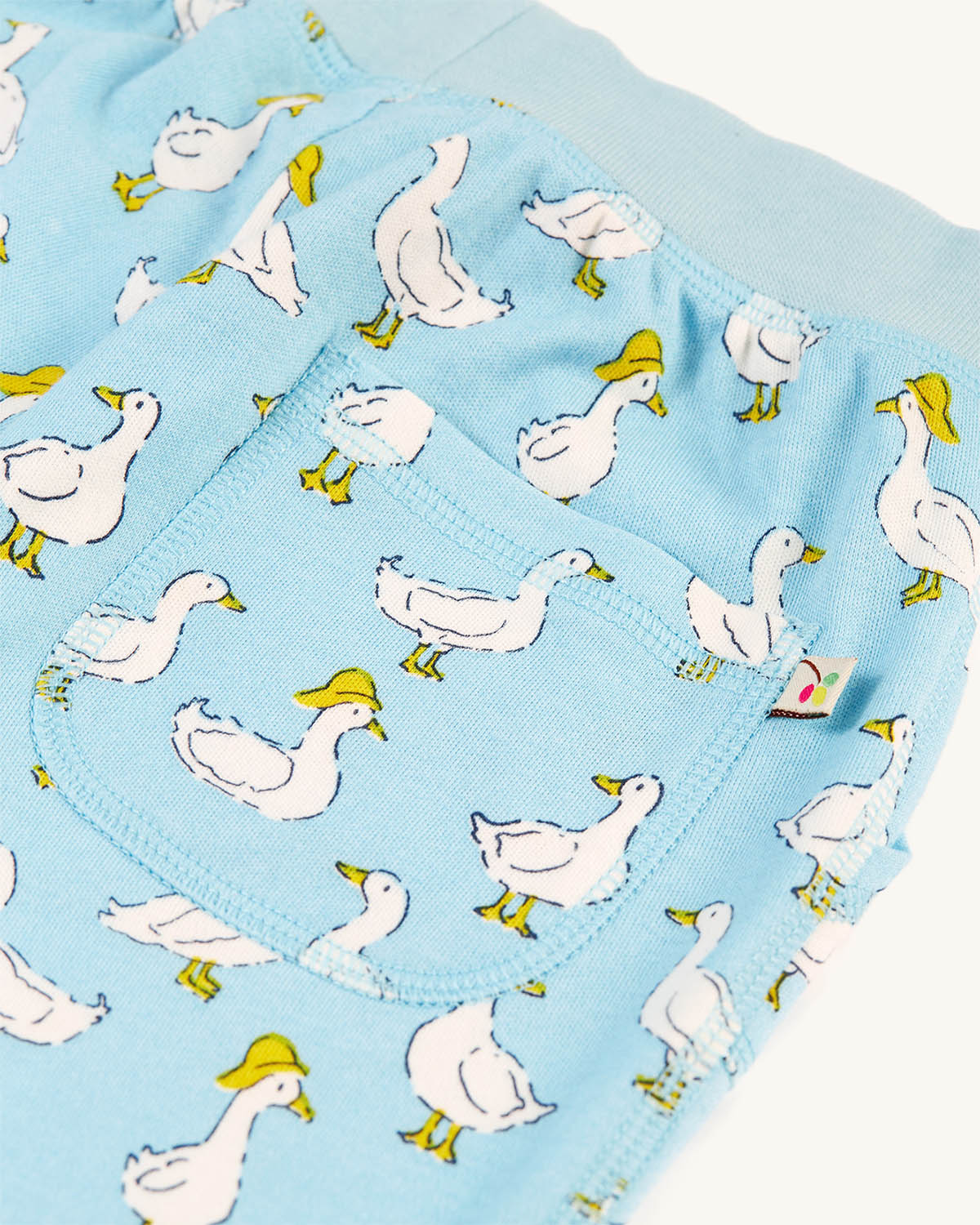 A closer view of the Frugi Children's Organic Cotton Aiden Printed Shorts - Splish Splash Ducks pockets on the front and a stretchy rib waistband with drawcord for an extra comfortable and great fit