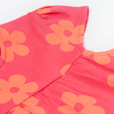 A close up of the Frugi little Lola floral fun / horse dress. Showing the short sleeve detail surrounded with light orange printed flowers on a pink organic cotton fabric