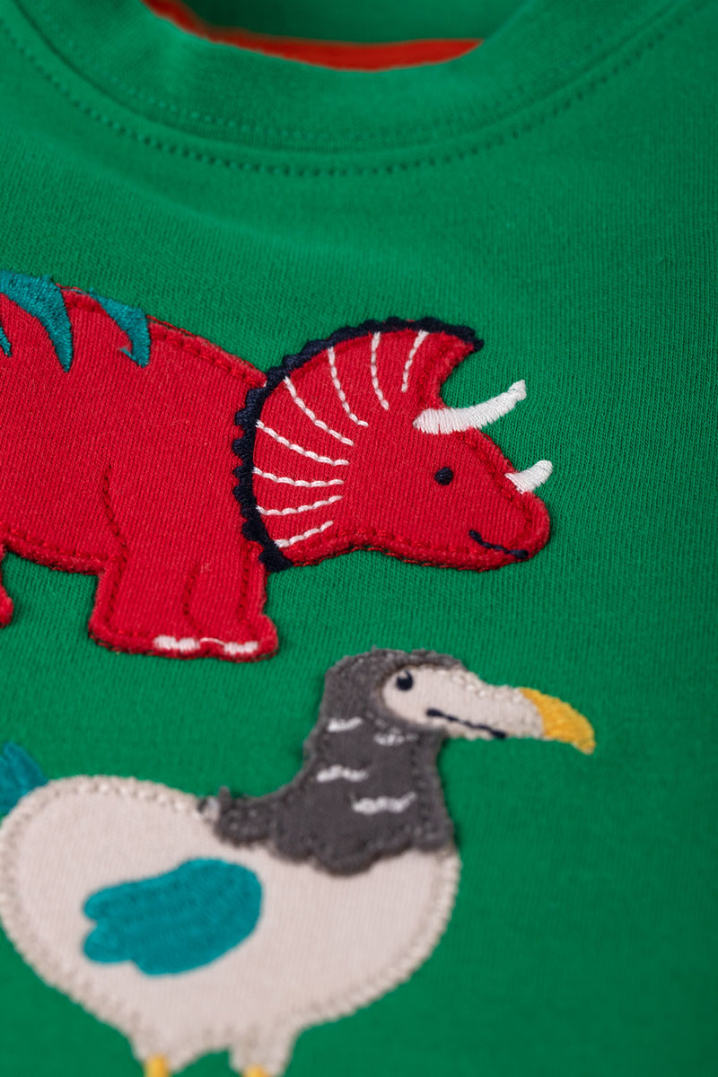 Close up of the red triceratops dino Frugi Little Creature Ribbit Green Dinos Applique Top 