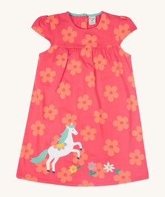 Frugi little Lola floral fun / horse dress - GOTS organic cotton baby dress in light pink with short sleeves and a light blue inside neck trim. Features a white horse appliqué with light green hair next to appliqué flowers surrounded with printed flowers