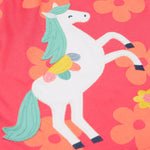 A close up of the Frugi little Lola floral fun / horse dress. Showing the white horse appliqué with light green hair next to appliqué flowers surrounded with light orange printed flowers on a pink organic cotton fabric