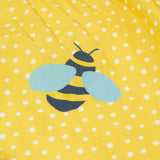 Close up of the Frugi kids lowen flower dress - Showing a yellow bee print on yellow with white spots organic cotton fabric