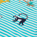 A close up of the Frugi kids moss stripe wildlife t-shirt. Showing the lemur applique detail next to the camel applique on blue and white stripe organic cotton fabric.