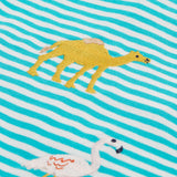 A close up of the Frugi kids moss stripe wildlife t-shirt. Showing the camel applique detail next to the pelican applique on blue and white stripe organic cotton fabric.