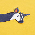 Close up of the Frugi kids bumblebee okapi short sleeve t-shirt. showing the head of the okapi animal appliqué on yellow organic cotton fabric