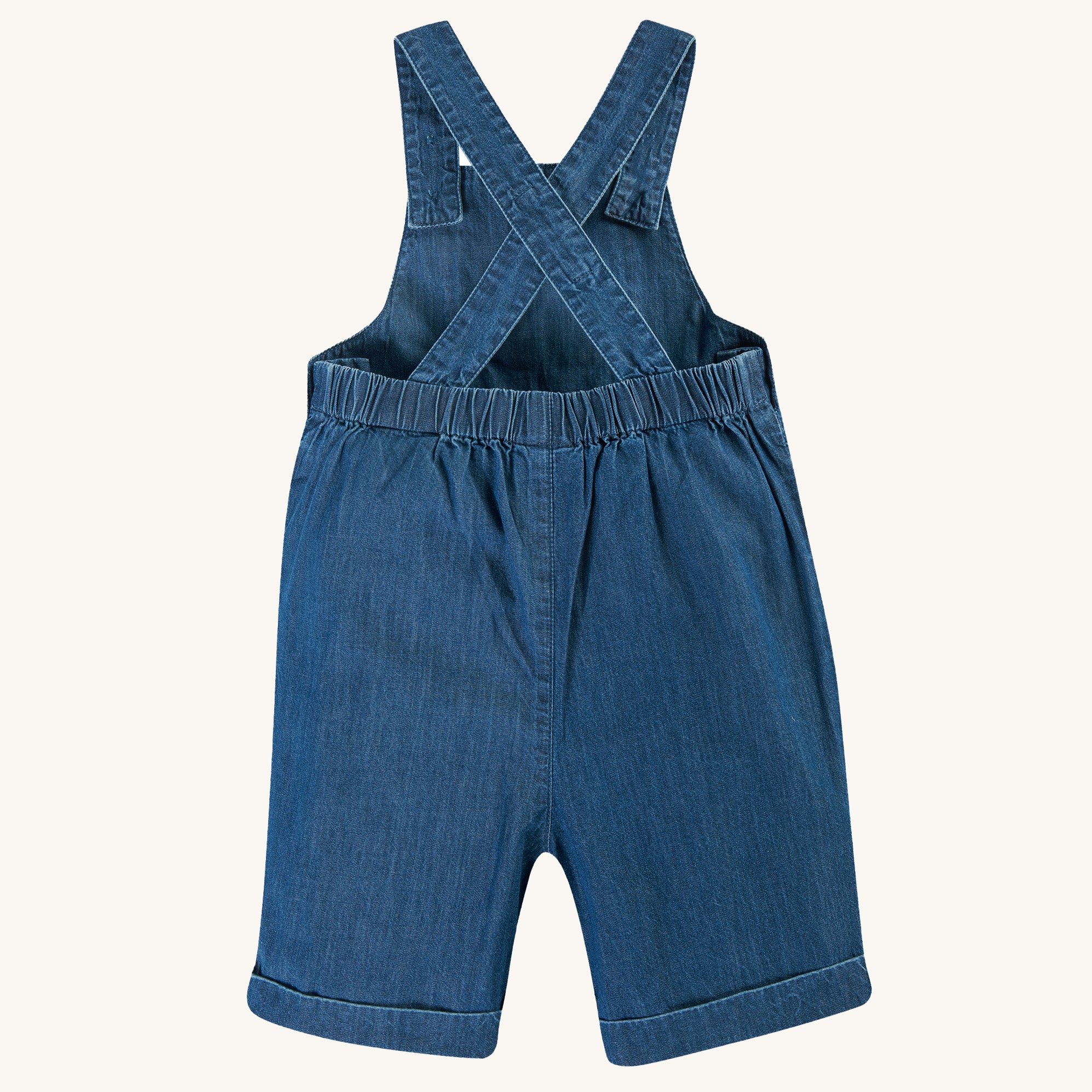  wearing the Frugi Organic Carnkie Chambray Denim Dungarees - Tractor and a light green t-shirt undernearth