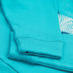 A close up of the Frugi kids oversized blue panda hoodie. Showing the arm cuffs on a light blue organic cotton fabric