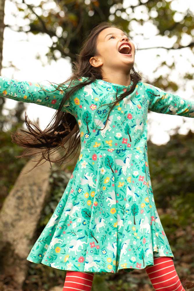 child wearing the Frugi Pegasus Flight Sofia Skater Dress outdoors