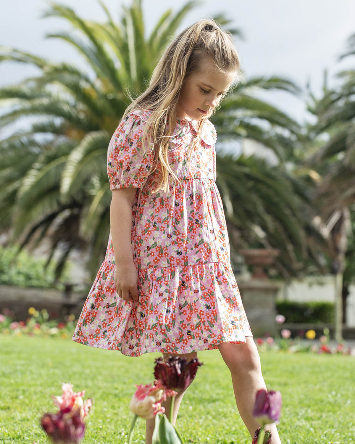  wearing the Frugi GOTS organic cotton Matilda Collared Dress - Pink Floral Fun. A playful spring-time print of white and red flowers