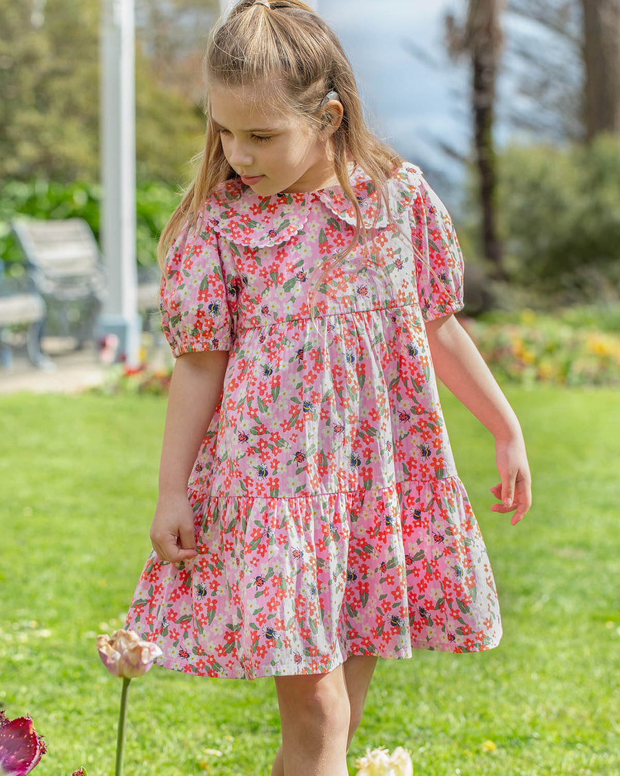 The back of the Frugi GOTS organic cotton Matilda Collared Dress - Pink Floral Fun. A playful spring-time print of white and red flowers