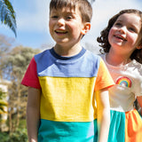 A child wearing the Frugi Rainbow Colourblock Treen Panel T-shirt.