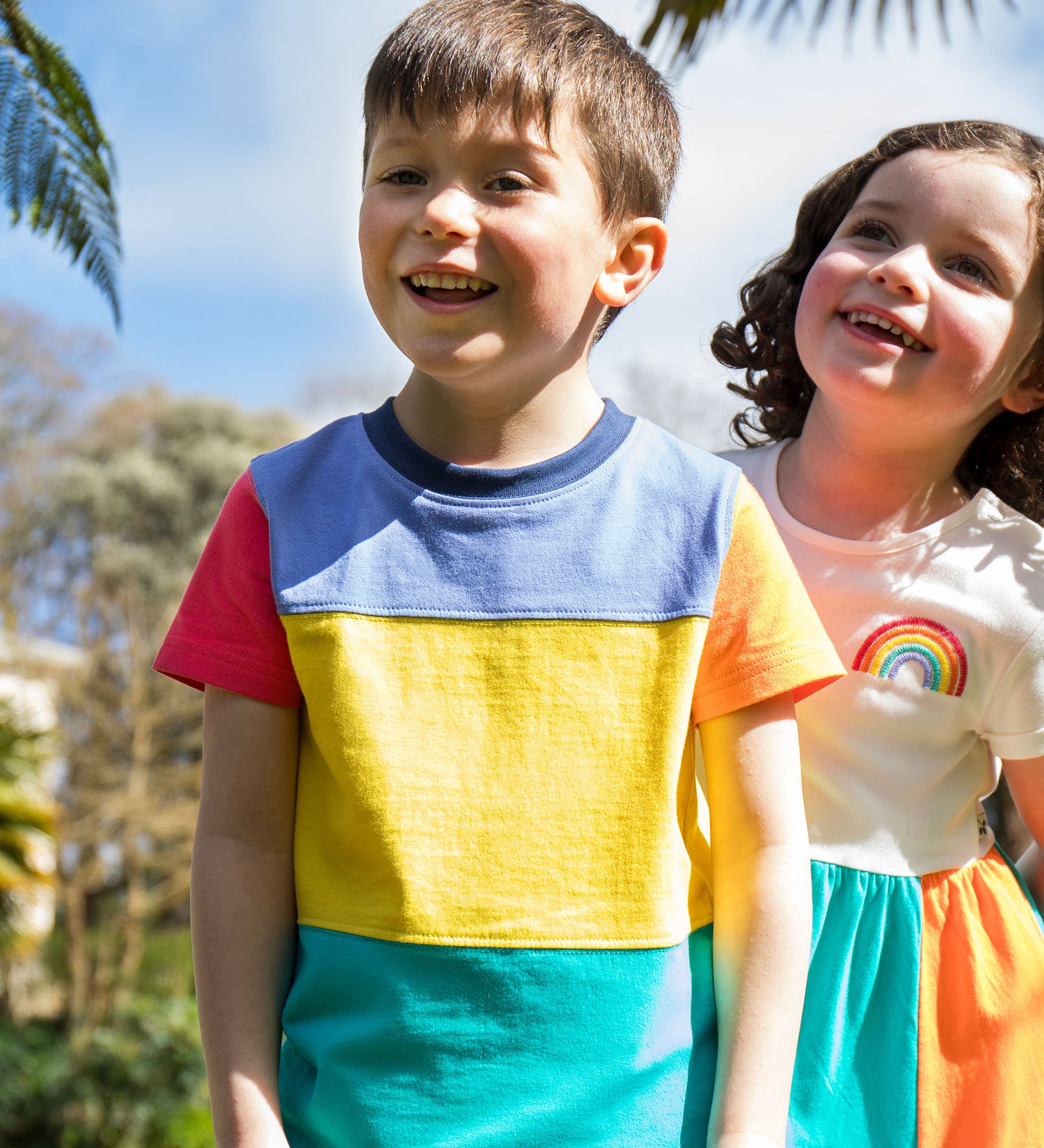 A child wearing the Frugi Rainbow Colourblock Treen Panel T-shirt.