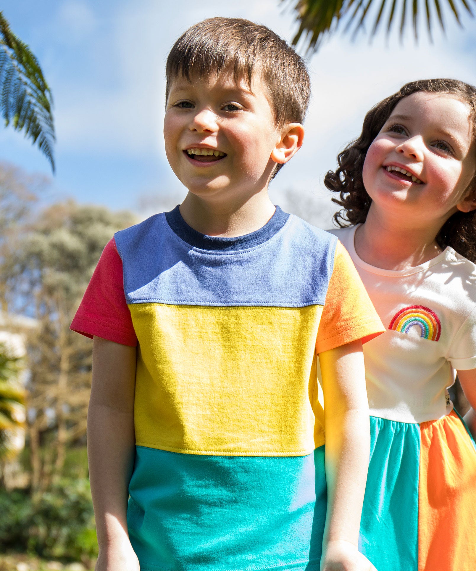 A child wearing the Frugi Rainbow Colourblock Treen Panel T-shirt.