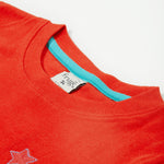 Close up of the Frugi kids red llama character t-shirt showing the red neck trim with light blue inside neck trim on red organic cotton fabric