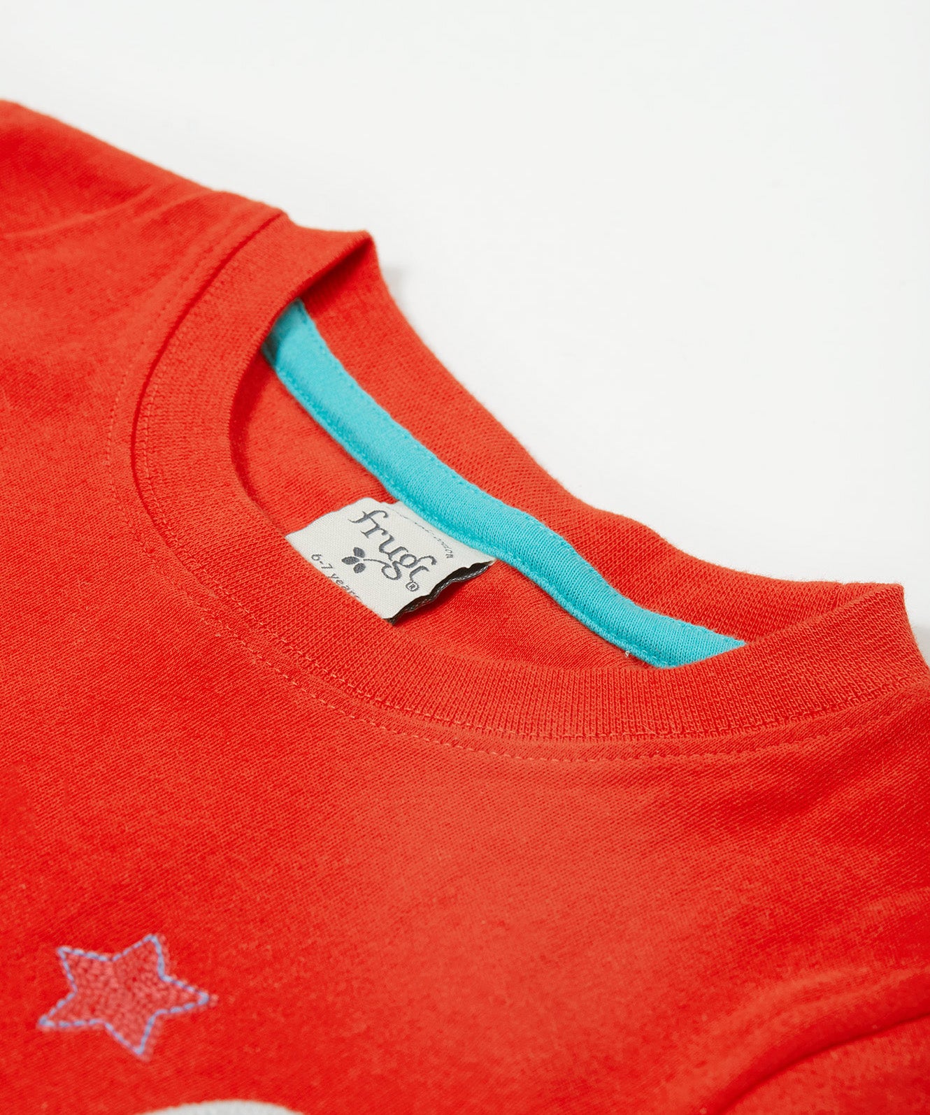 Close up of the Frugi kids red llama character t-shirt showing the red neck trim with light blue inside neck trim on red organic cotton fabric