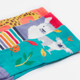 Close up of the Frugi kids rock my socks 3 pack, zoologist. Showing all 3 bright fun Frugi zoologist socks including a grey koala, white llama and a giraffe sock on organic cotton fabric