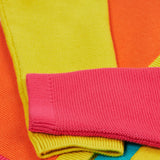 Close up of the Frugi kids Rose pocket cardigan, happy pen pot. Showing the pink and yellow arm cuff on organic knitted cotton fabric