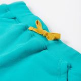 Close up of the Frugi kids sea moss Samson shorts showing the yellow waist drawstring on turquoise organic cotton fabric