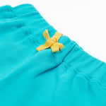 Close up of the Frugi kids koala shorts showing the yellow waist drawstring on blue organic cotton fabric