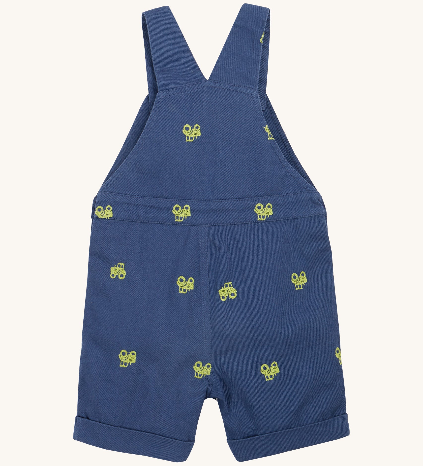 Frugi baby short navy tractor dungarees - GOTS organic cotton baby dungarees in navy blue showing the shoulder strap back detail. Features a green tractor embroidery all over the dungarees.