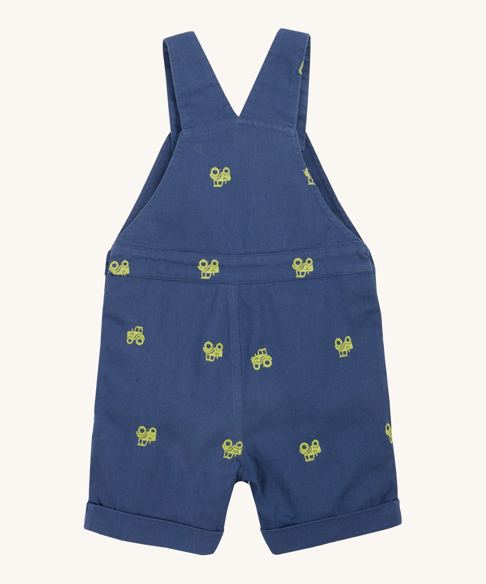 Frugi baby short navy tractor dungarees - GOTS organic cotton baby dungarees in navy blue showing the shoulder strap back detail. Features a green tractor embroidery all over the dungarees.