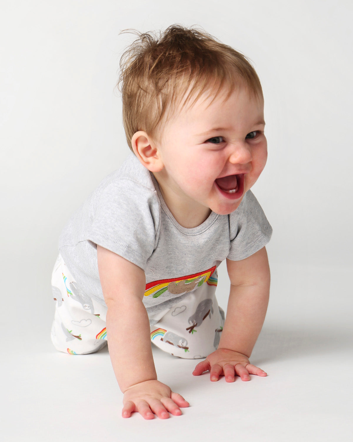 A close up of the white cuffed sloth and rainbow pull ups print